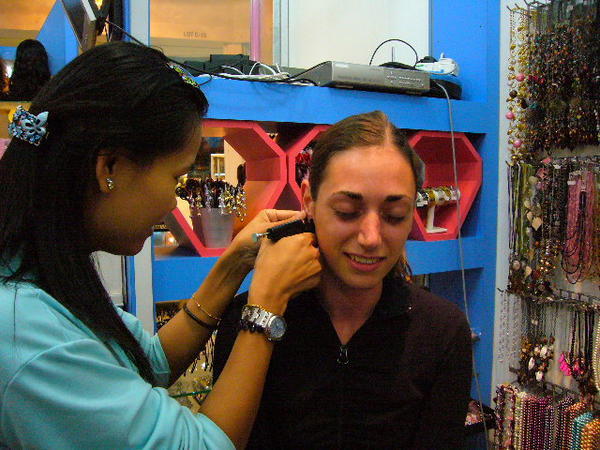 Amanda getting her ears pierced.
