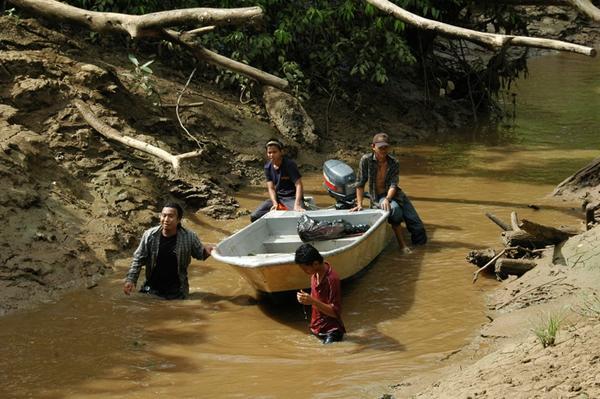 The lads getting our boat through a tributary that was very low
