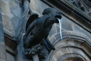 An ice gargoyle tongue in the shade of Prague's cathedral
