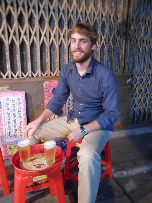 This is how you drink beer in Vietnam - on the side of the road in tiny plastic chairs