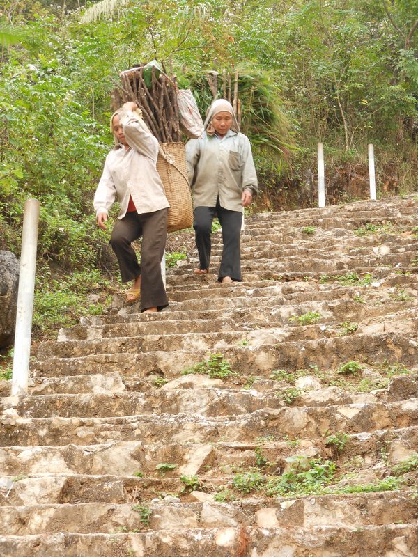 Some locals descending the stairs to the cave