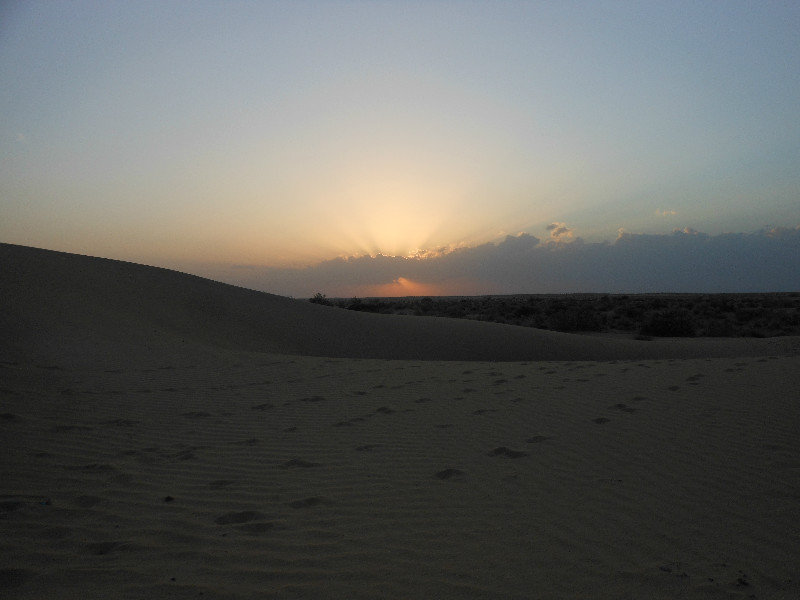 Sun disappearing over the dunes