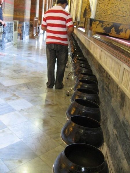Money pots for donations to Buddha.
