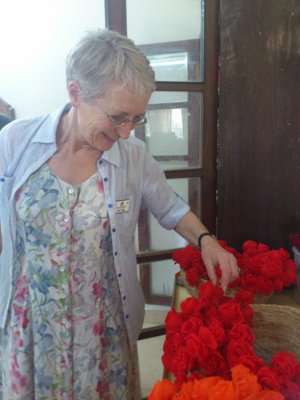 Angie admiring the synthetic flowers made at Asare School