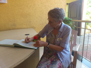 Angie signing the register at Asare School