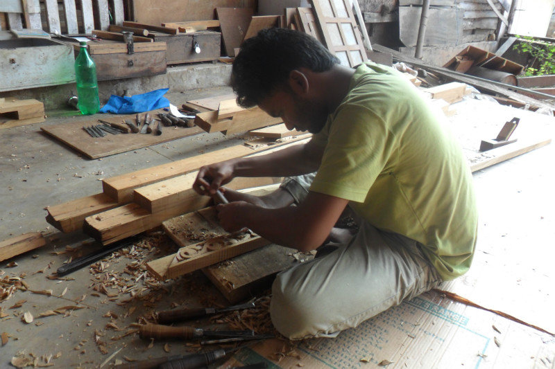 Workers carving the wood