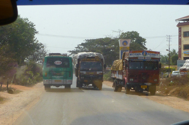 three lorries trying to overtake each other as we approach in our minibus