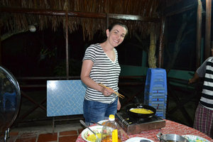 Mekong River -  Christine cooks up rice flour pancakes for dinner