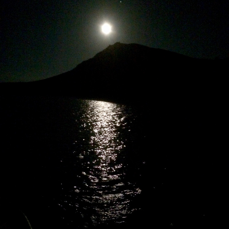 I See the Bright Moon Rsing over an island volcano cone