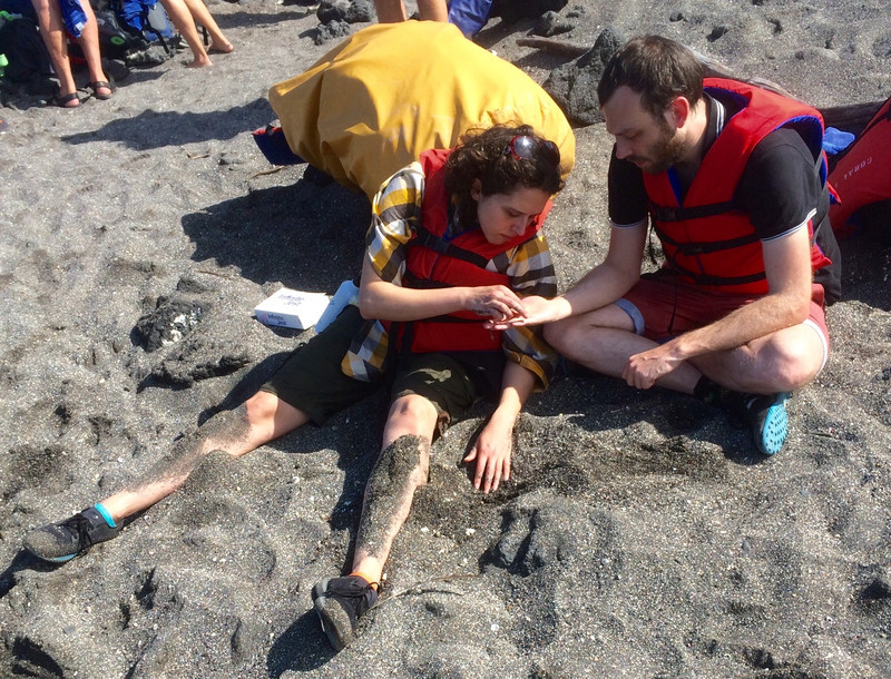 Caroline examines what Max found on volcanic Urbina beach