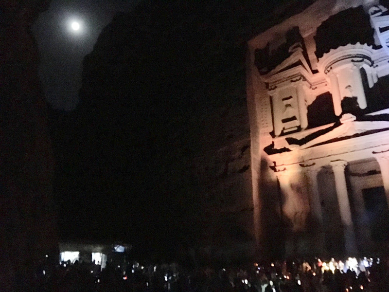Moon in mountain gap shines onto Petra treasury