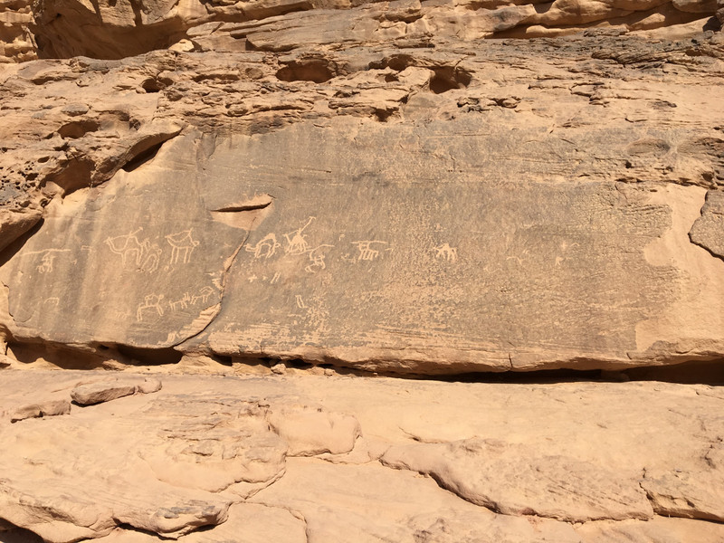 Caravan drawing on desert rock