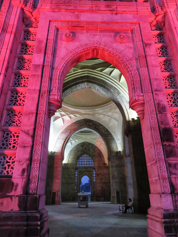 Arch of the Gateway of India lit up with bright pink light