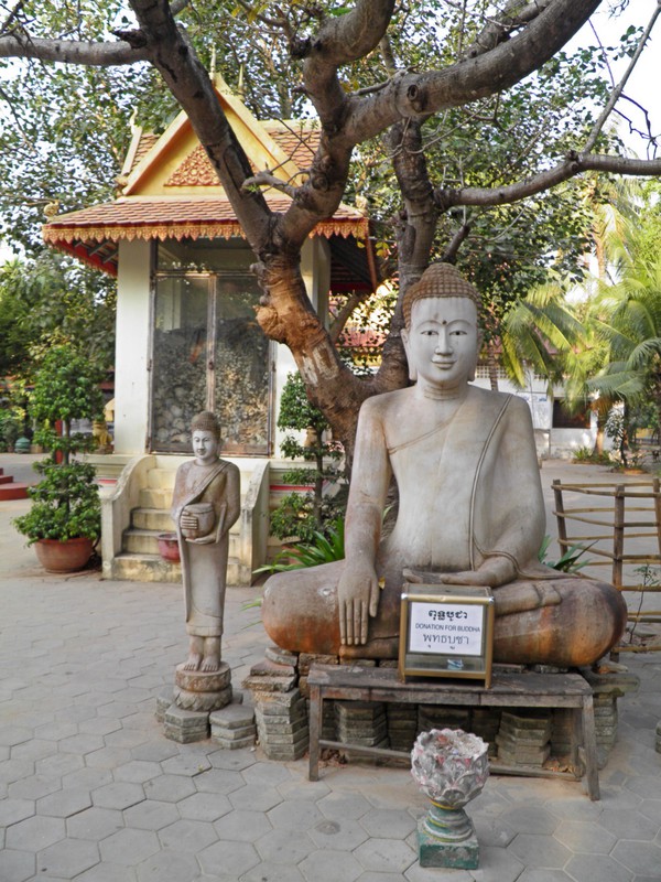 Wat Thmey buddha with memorial in background