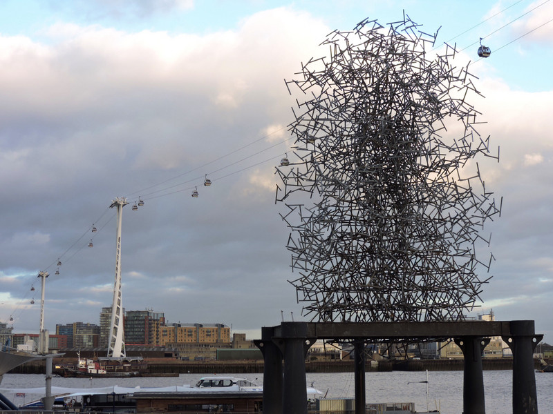 Dockside sculpture with cable cars in background