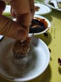 Dipping meat into sugar