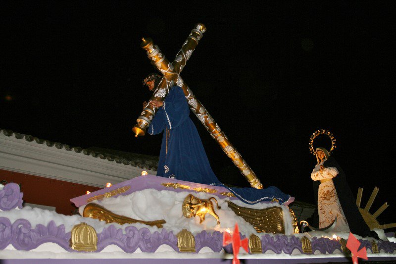 Jesus carrying the cross while Mary looks on woefully