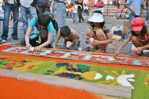 Kids work together to make a sand mosaic