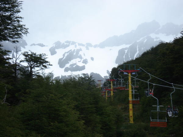 the chair lift and snow capped mountains