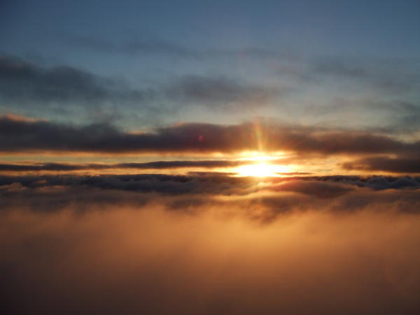 the sunrise as we soar above the clouds