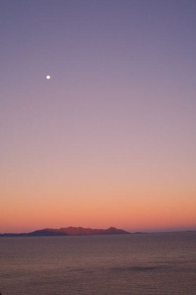 sunset, the moon in the distance 