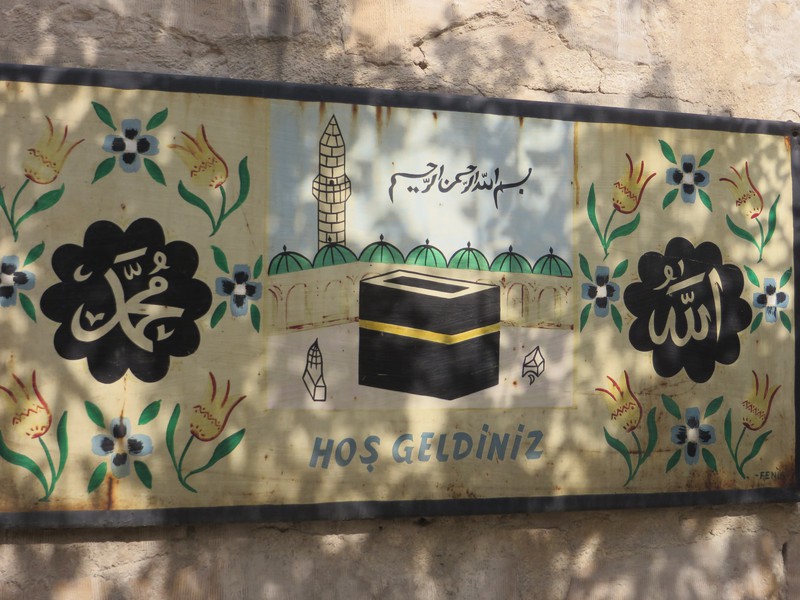 Sign hung in courtyard stating the family had made the pilgrimage to Mecca. 
