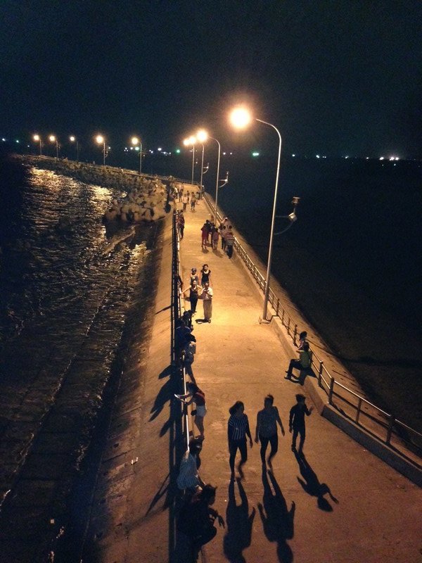 Locals strolling along the breakwater
