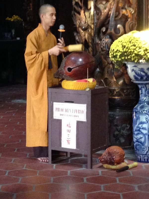 Monk bingbonging and chanting right on top of the donation box