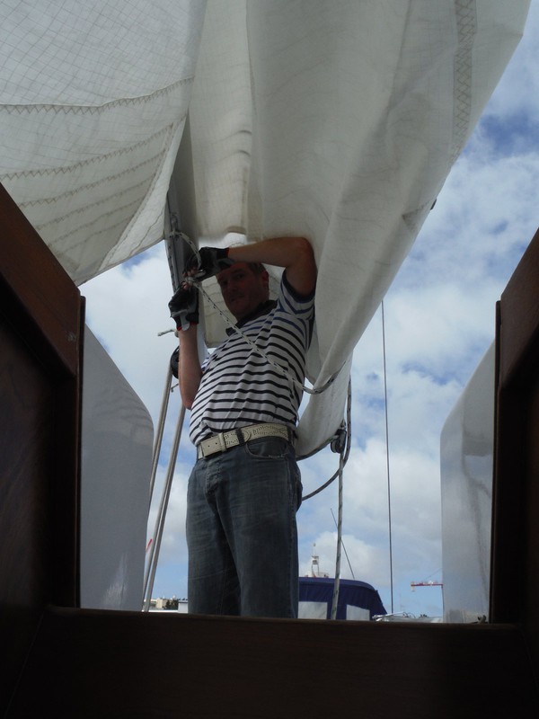 Mike putting the main sail back on