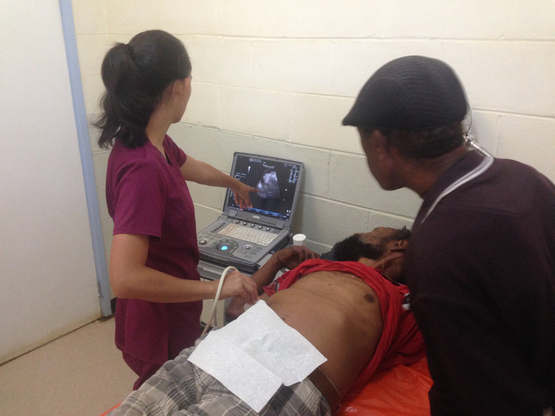 Dr. Sheryl using the ultrasound on a patient