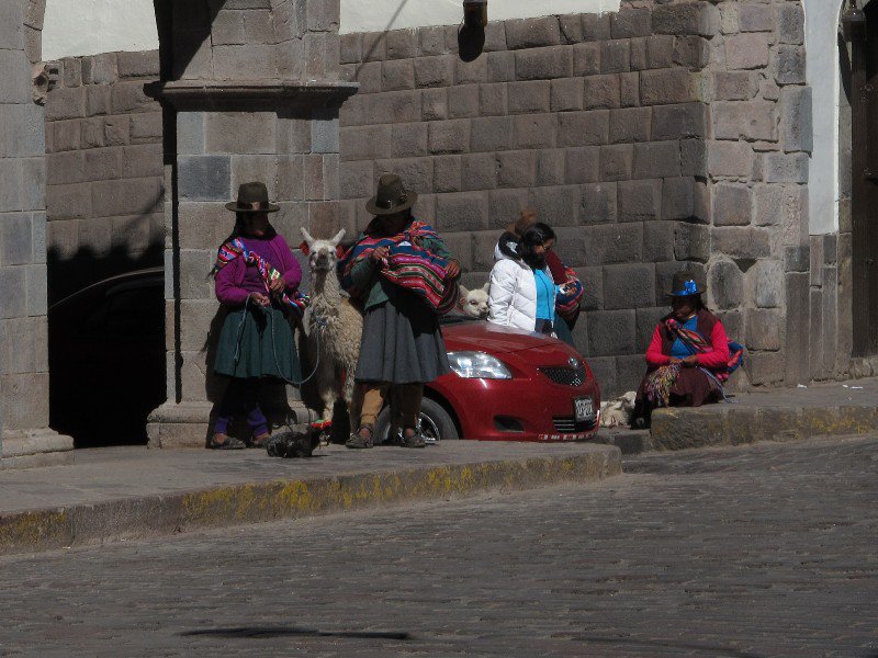 Locals trying to convince gringo's to have a photo with a Llama