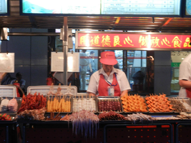 Market stall featuring skewered squid, prawns and lobster