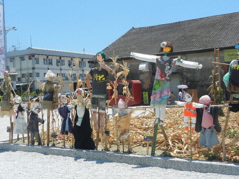 Pier-2 Art District scarecrows in front of cornfield