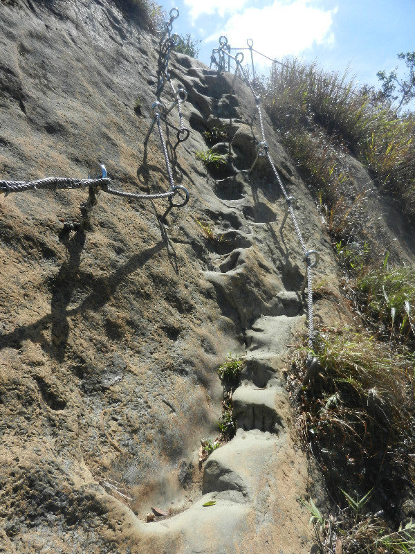 Steps carved into rockface and support ropes at Pingxi