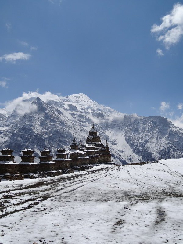 Stupas and prayer wheels with kangaru mountain in background