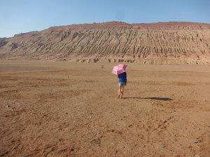 Becky walking towards the scorching Flaming Mountains