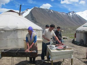 Kazakh minority people barbecuing lamb