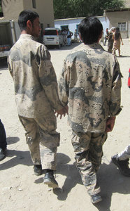 Afghan guards at the market in Khorog, walking hand in hand
