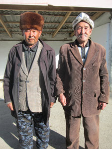 at a bus stop. Men always take this pose when they are being photographed. 