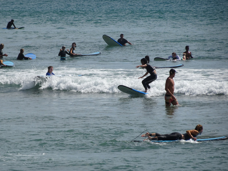 learning to surf the small waves of Kuta Beach