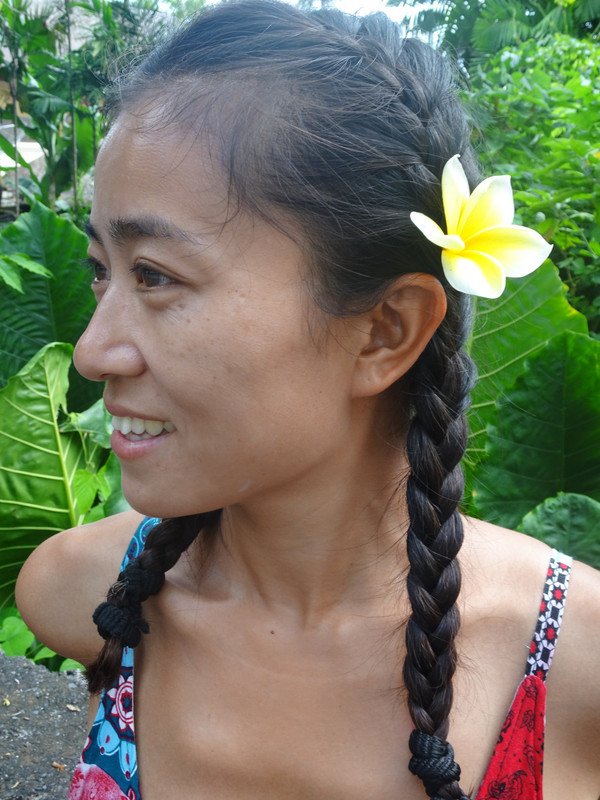 a plumeria or frangipani flower in Becky's hair