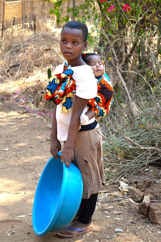 Girl carrying child