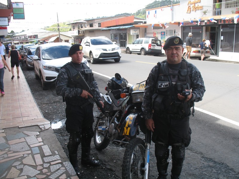 Two Officers ride this dirt type bike carrying a machine gun