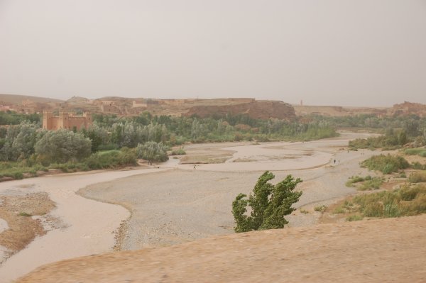 Riverbed and kasbah on the side of the road