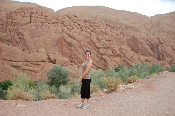 Laure standing in front of the rock formation in the Southern Oasis region 