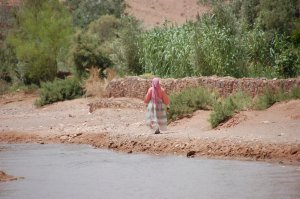 Berber woman walking along the river at Ait Benhaddou