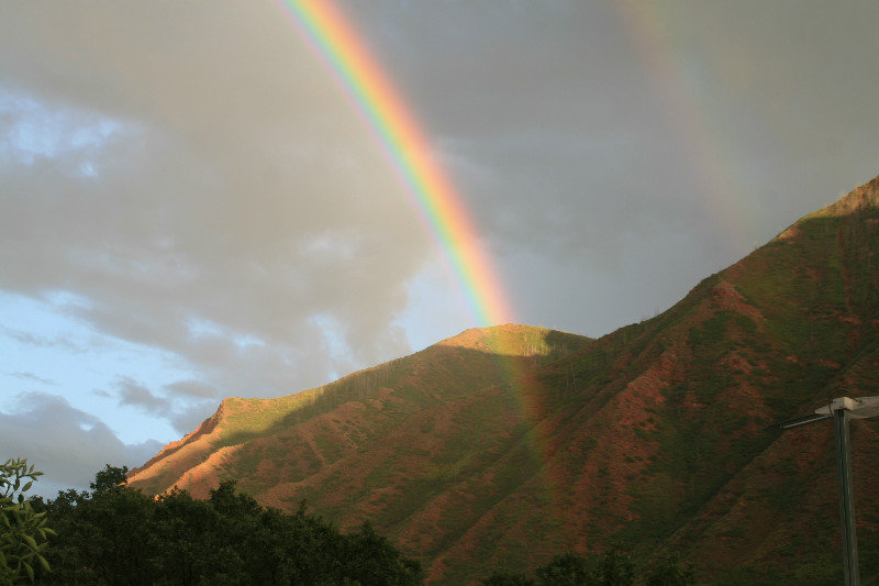 Double rainbow disappears into mountain