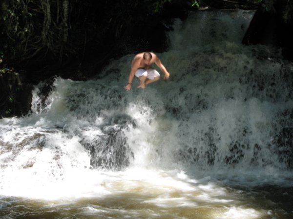 Phil jumping into a waterfall