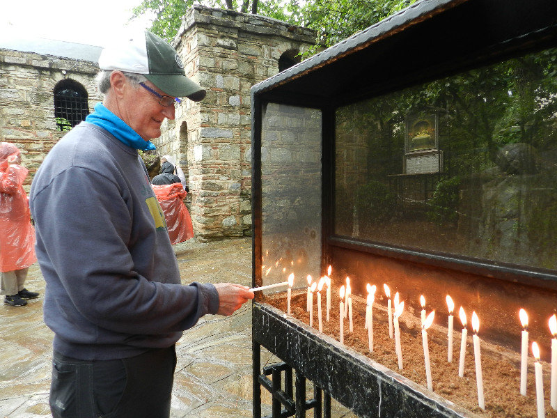 Tim lighting candles to honor his Mom and Dad