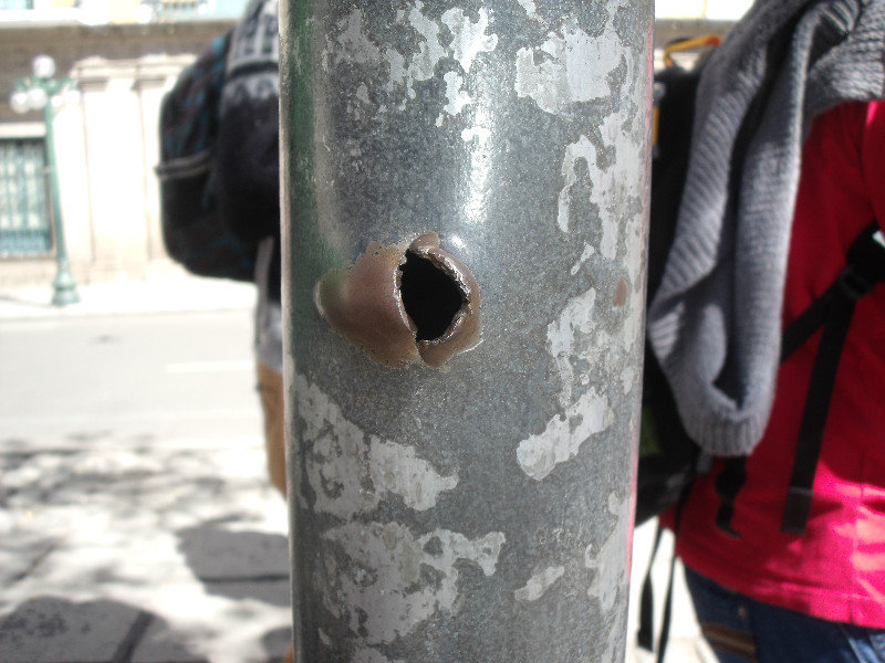 Bullet holes from gunfighting in front of the presidential palace
